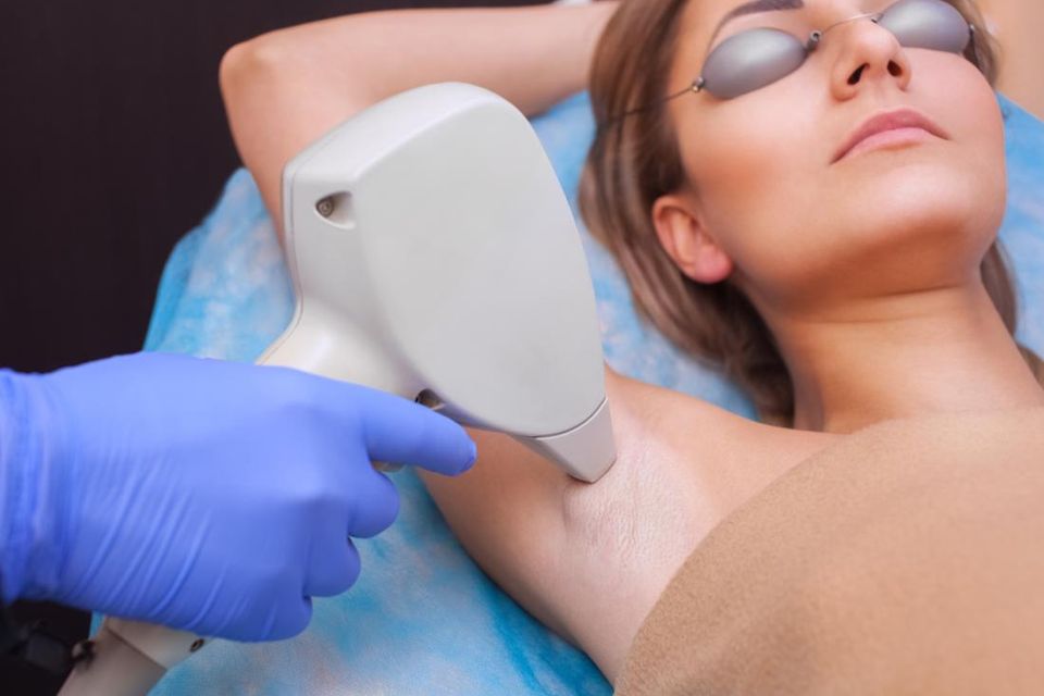Woman having laser hair removal on her armpit