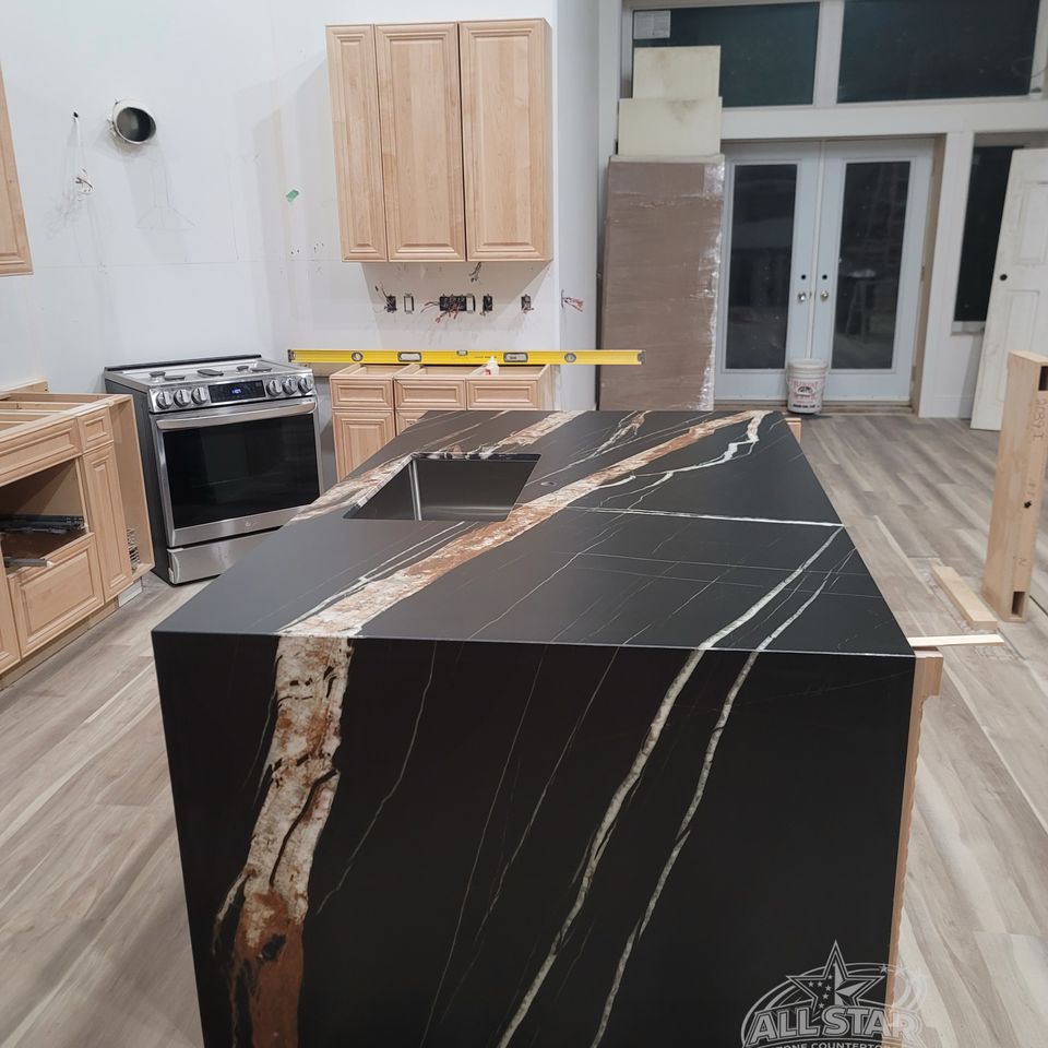 Black waterfall kitchen island with custom stone countertop installation Houston, TX