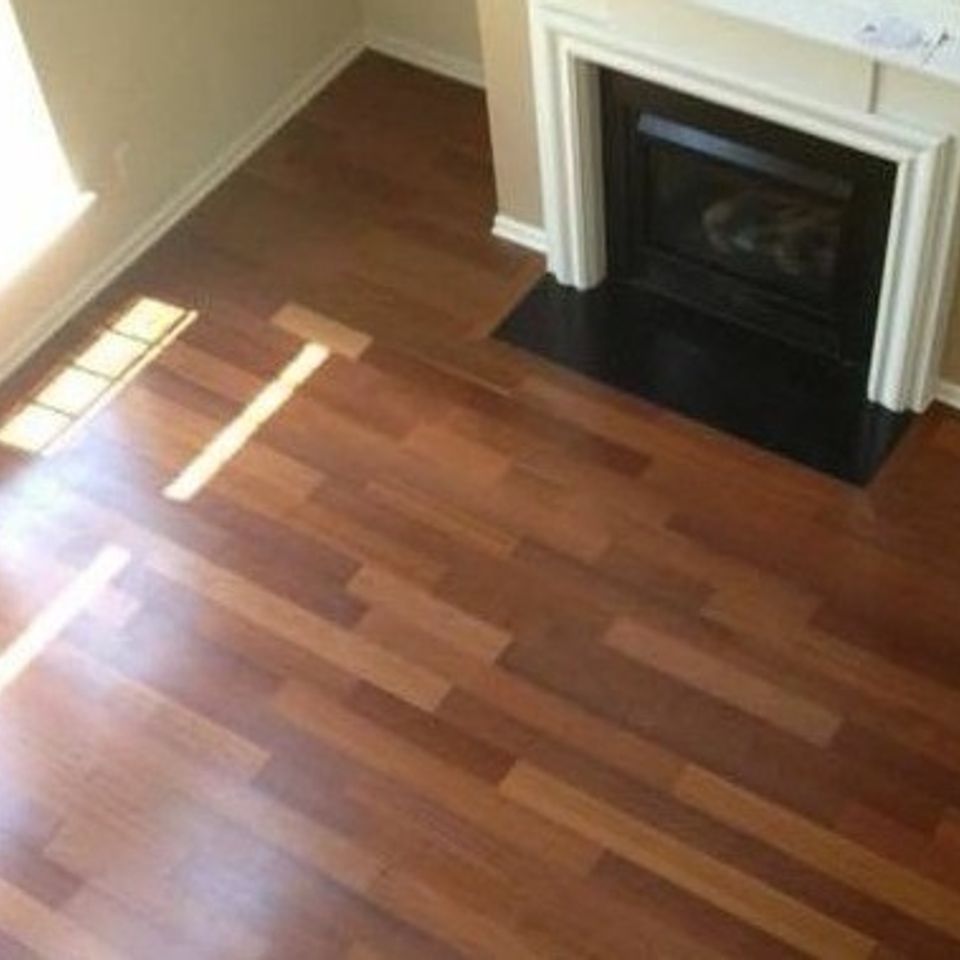 Residential hardwood installation in a Raleigh homes living room with fireplace.