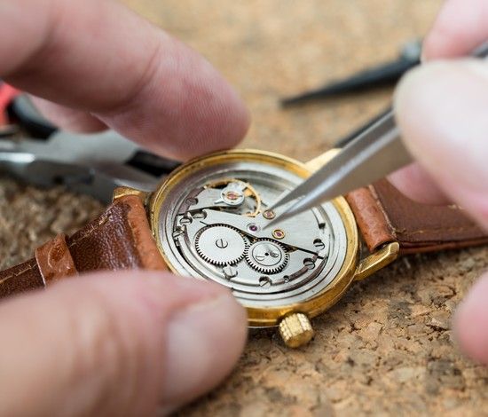 Watchmaker adjusting watch