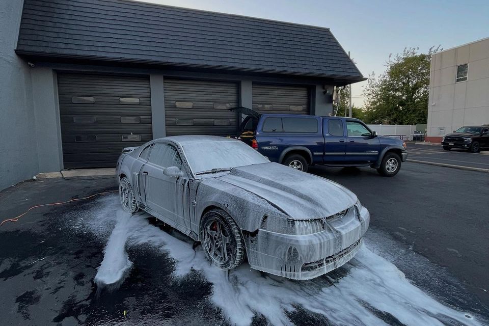 Ford Mustang GT covered in thick foam pre-wash during a mobile exterior cleaning in Wilmington DE