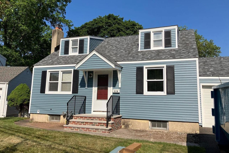 house with blue siding and new roof
