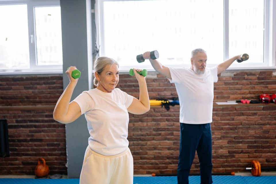 Adults improving strength and mobility through wellness coaching