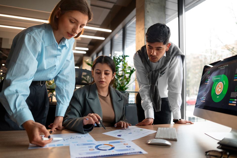 People analyzing checking finance graphs office