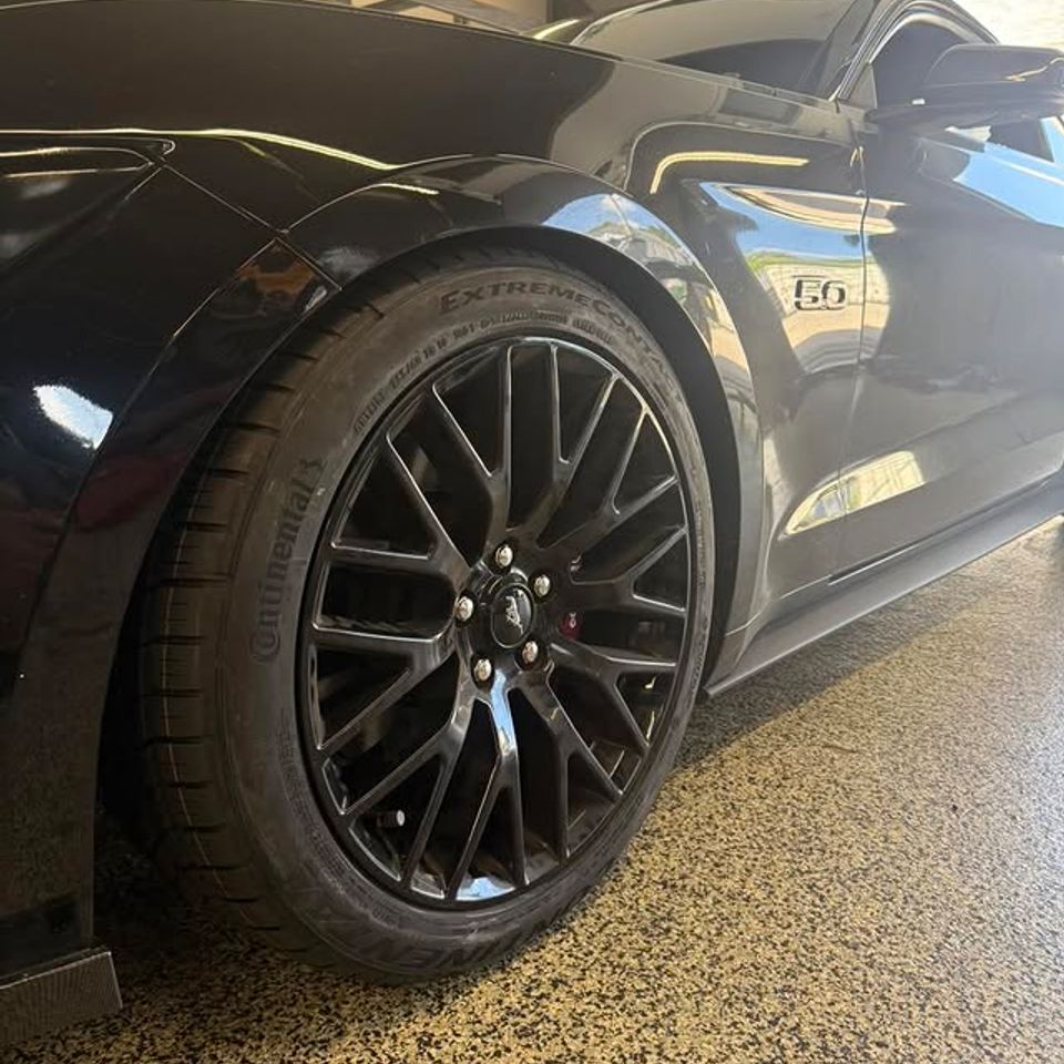 Black Ford Mustang 5.0 with new black multi-spoke wheels and Continental tires in Claymont DE