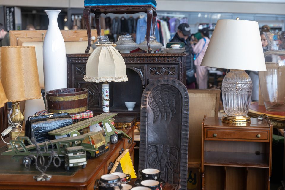 Barcelona march 14 2023 typical stall els encants flea market placa de les gloriesa lamp with white rag lampshade style seventies wooden carved picture