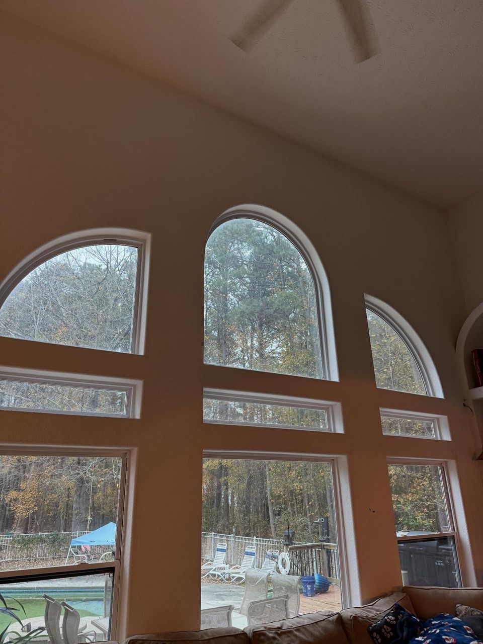 Tall arched living room windows with residential window film installed in a Moyock North Carolina home