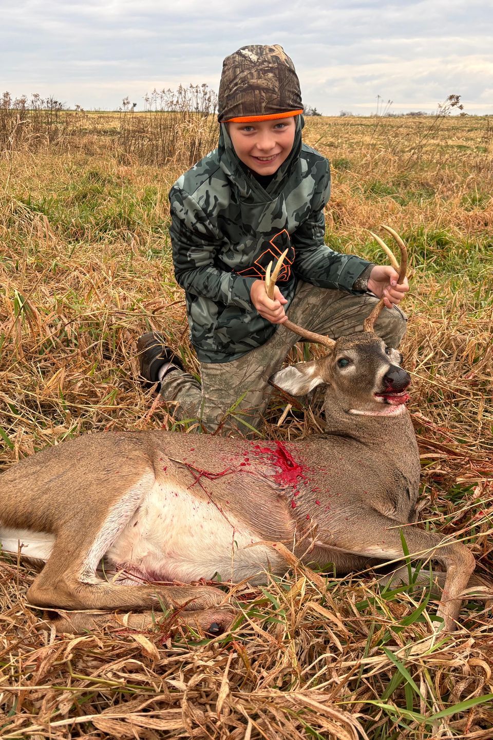Gavin and his buck. Photo by Jake Boyer