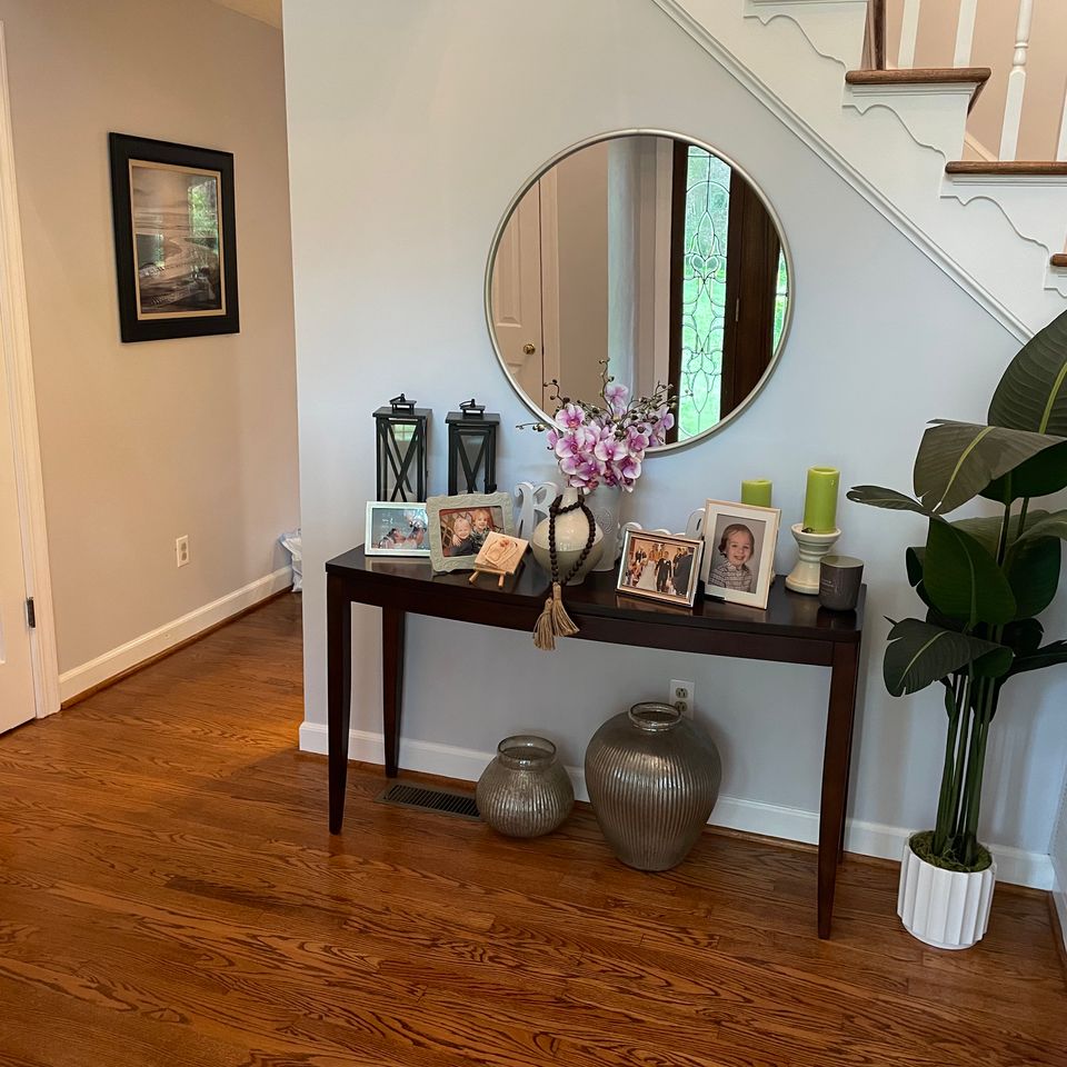 Tidy entryway with dusted console table and mirror after a house cleaning service in Virginia Beach VA