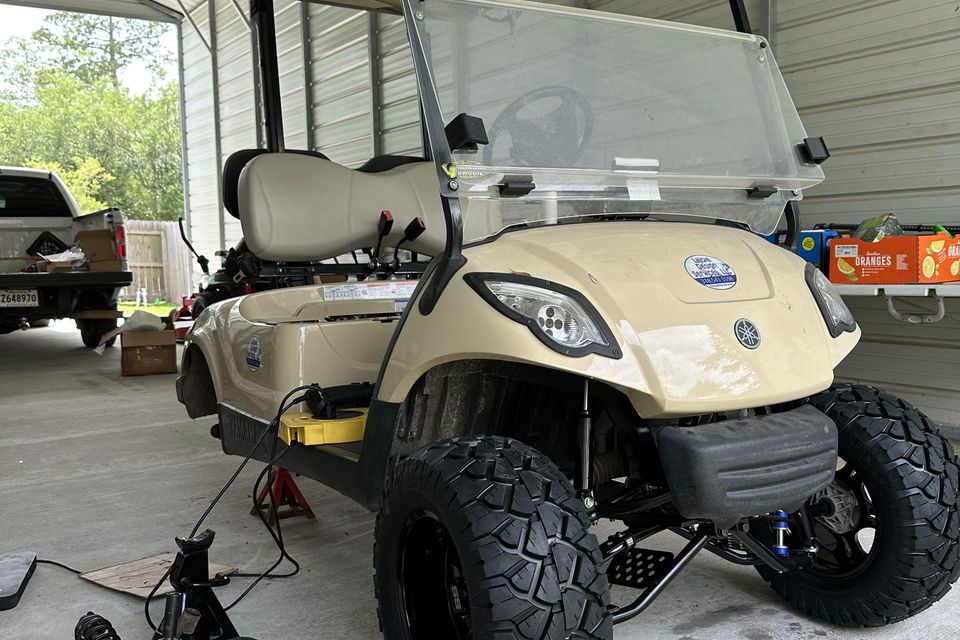 Golf cart brake job with wheel removed by Neighborhood Golf Carts in Madisonville, LA