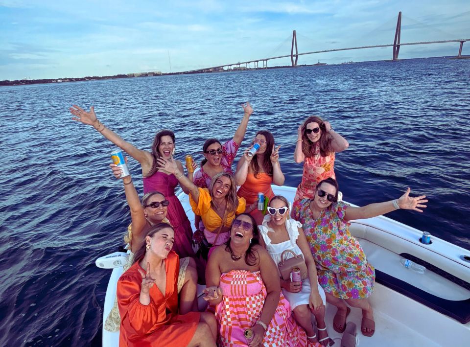 Bride and friends celebrating a colorful Charleston bachelorette party on a boat near Shem Creek