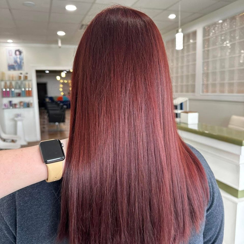 Long sleek straight deep red hair with glossy finish after color service in Columbiana AL