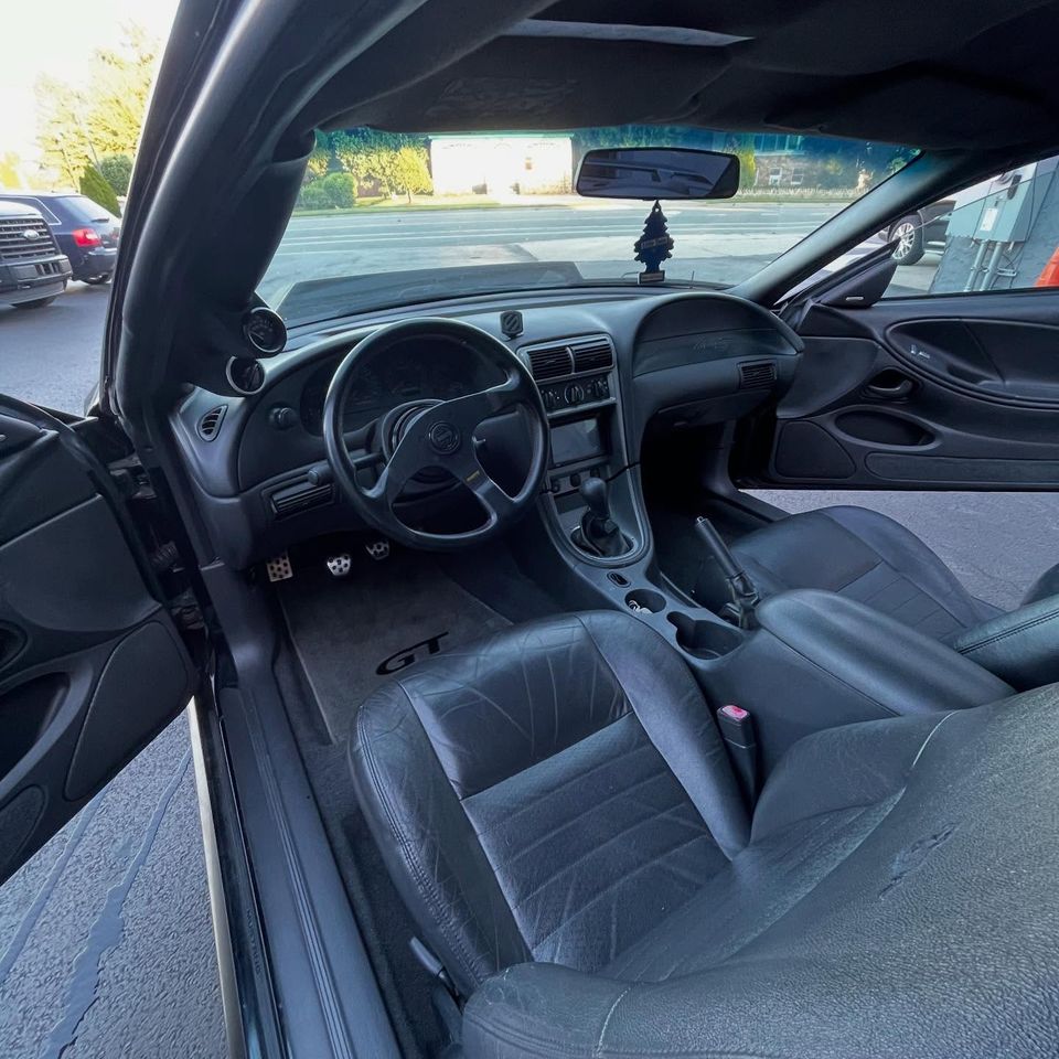 Freshly cleaned Mustang GT cockpit with leather seats, dash, and GT floor mats at a Wilmington Delaware detail
