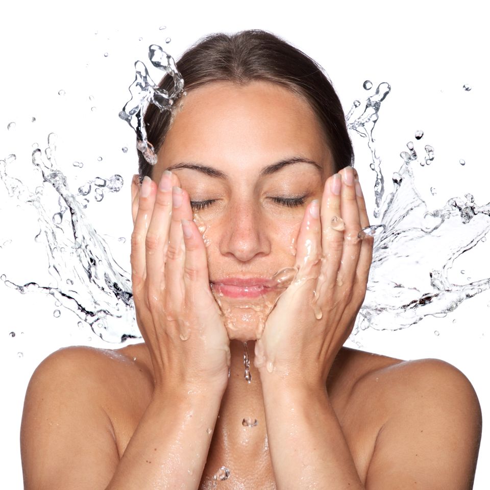 Woman splashing water on her face representing Inner Beauty deep hydration IV therapy