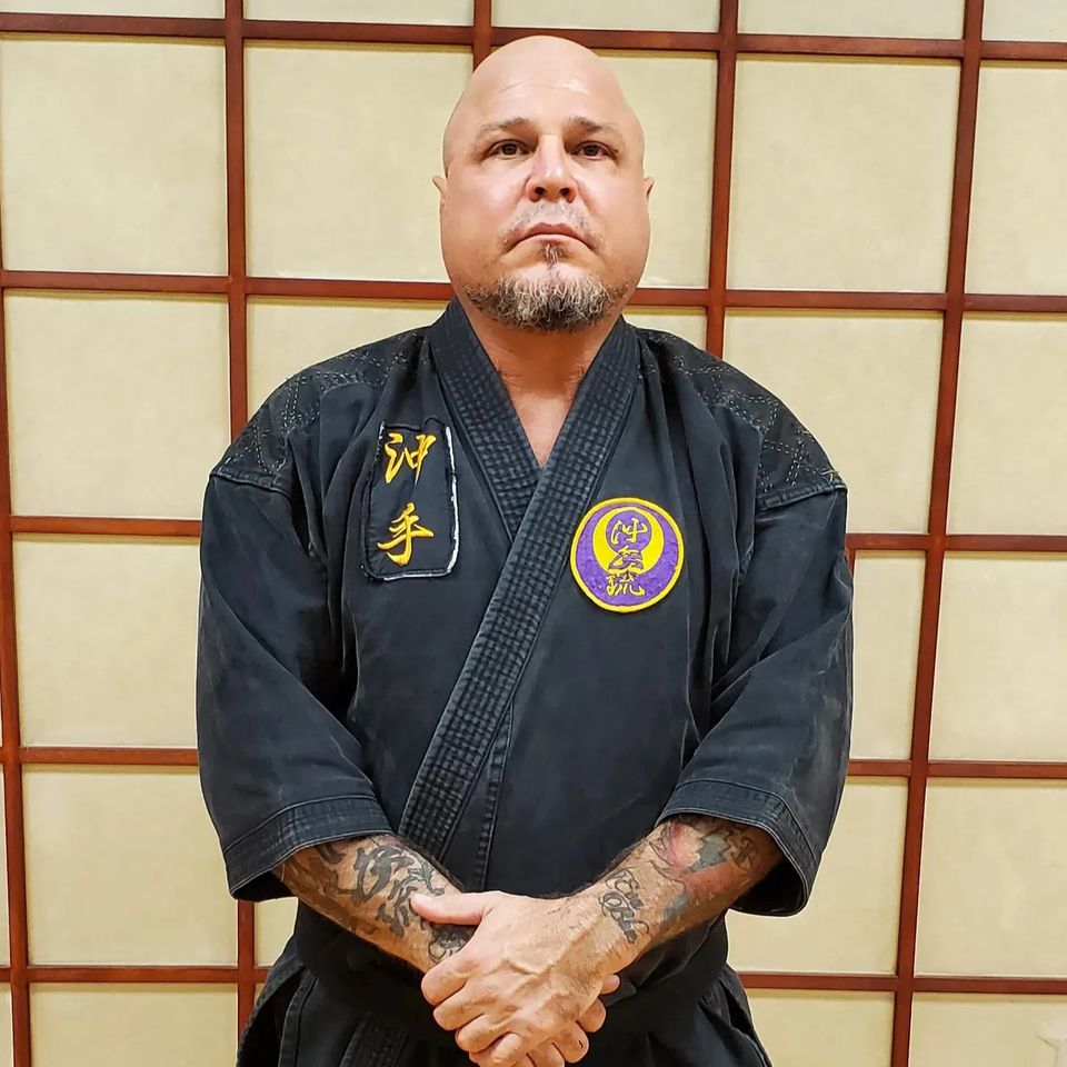 Renshi Patrick Trovato posing for a photo at Takamine Karate Dojo in Miller Place