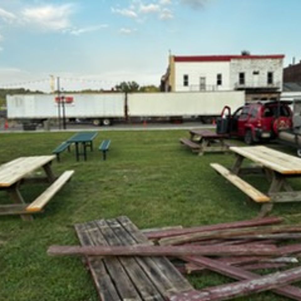 Outdoor picnic table seating area at Lickers Hometown BBQ.