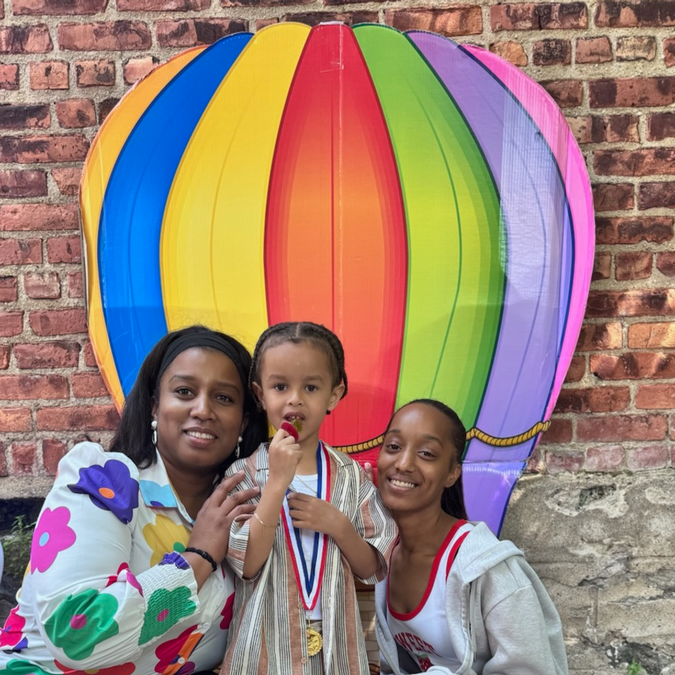Kidz heavenly garden ms elisa with parent and child at graduation