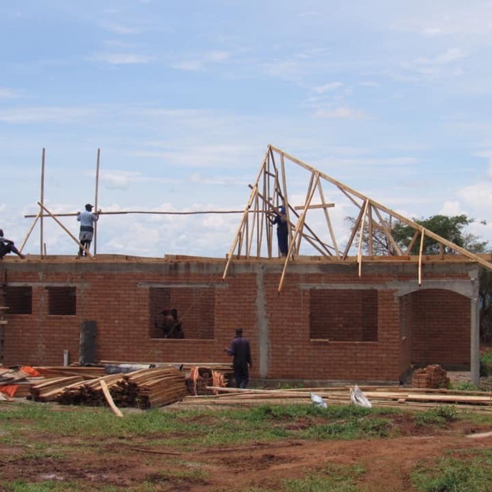 Putting up roof support in uganda