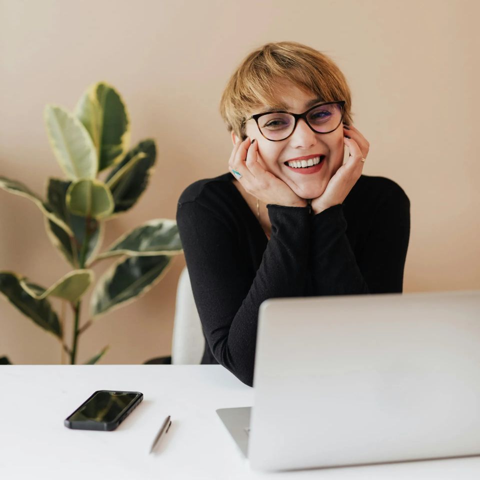 Woman with laptop happy about virtual therapy