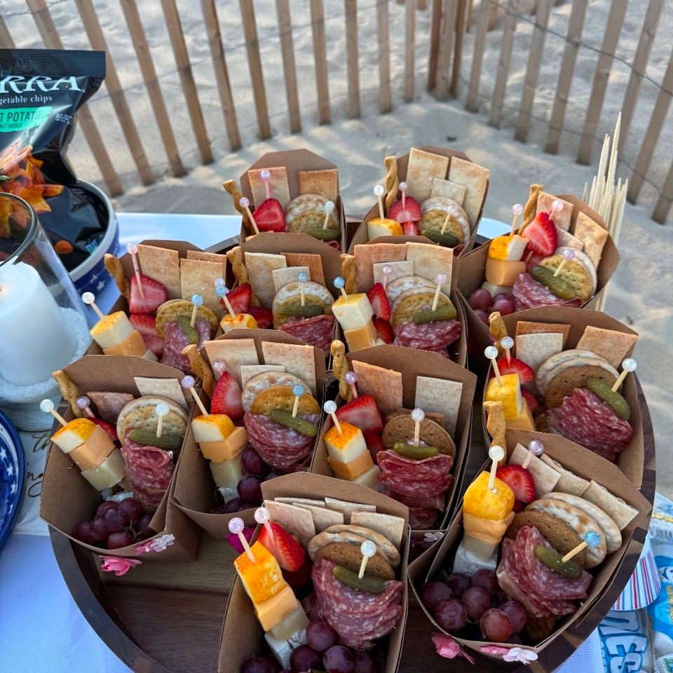 Individual charcuterie cones with salami, cheese, and berries served at a Hamptons NY beach picnic