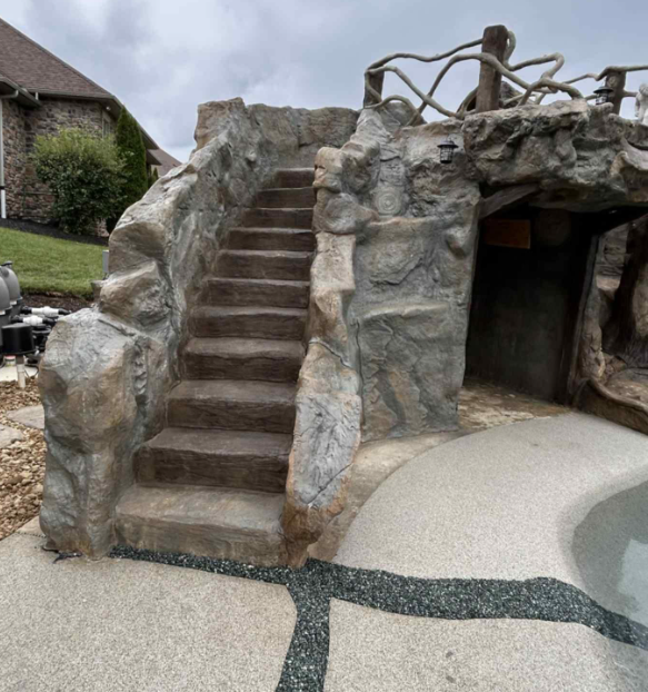 ClifRock Outdoor pool feature with rock-textured steps, cave-like opening, and concrete pool deck.