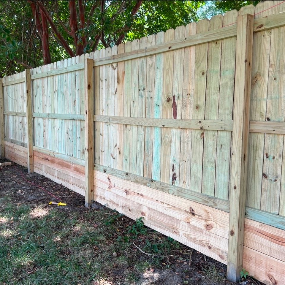 Wood privacy fence with kickboard installation along residential property line in Virginia Beach VA