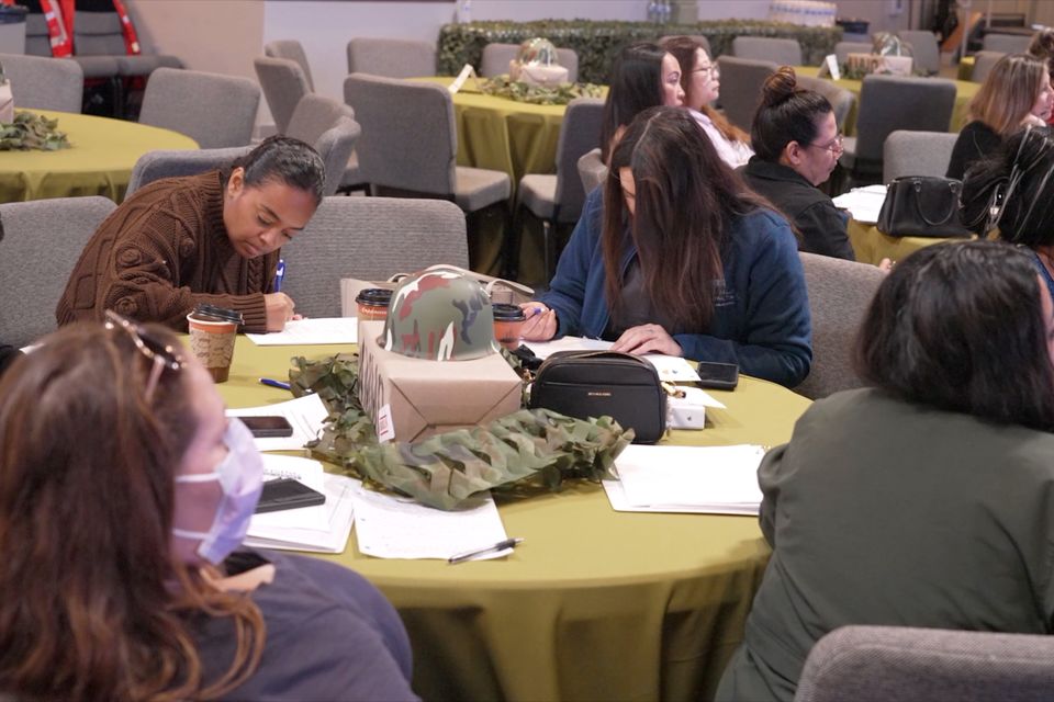 People writing at a table