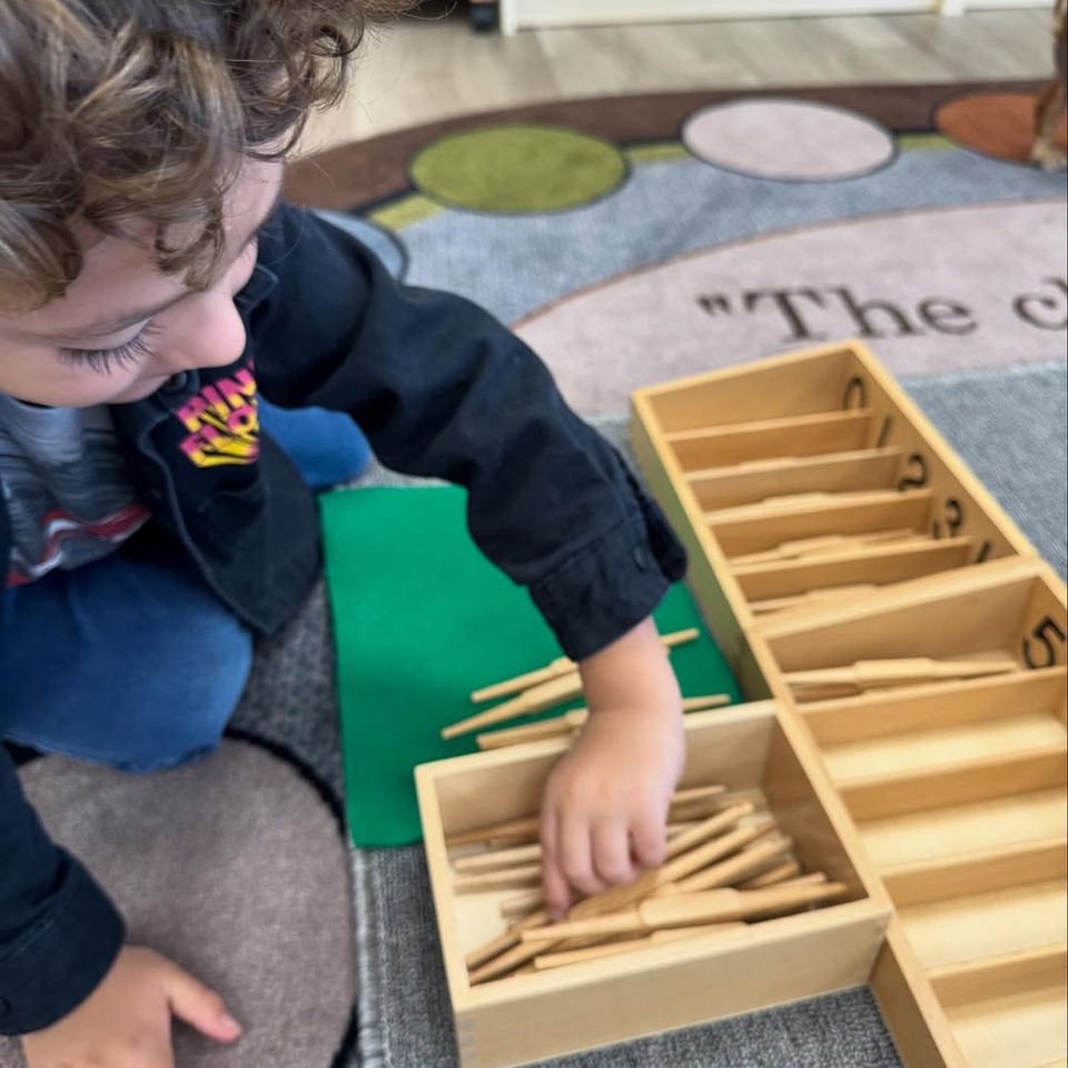 A child at Montessori Magic Key in Palmdale, CA playing a fun numbers game 