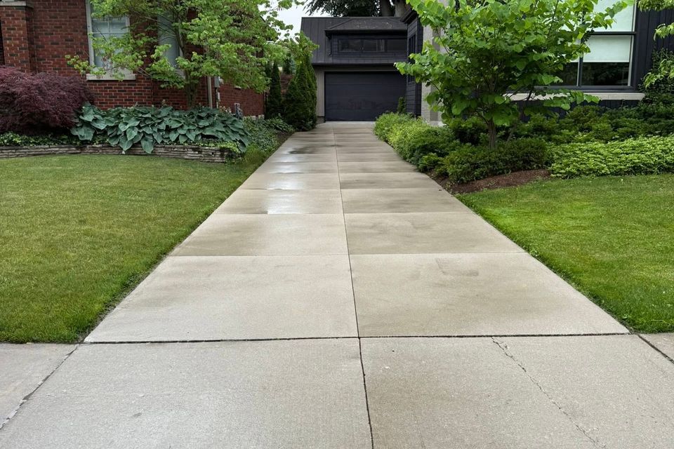 Clean concrete driveway and walkway after pressure washing at a residential property in Tillsonburg Ontario
