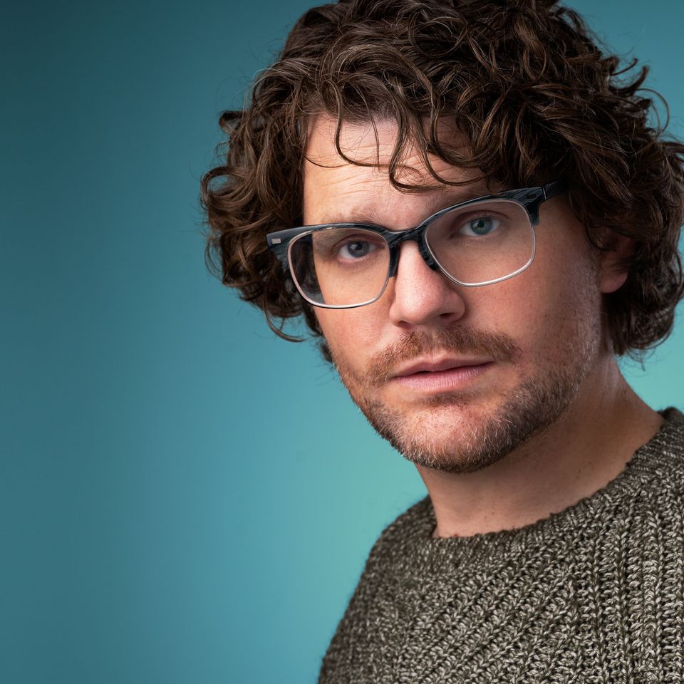 Sean glasses blue background wide crop rule of thirds min