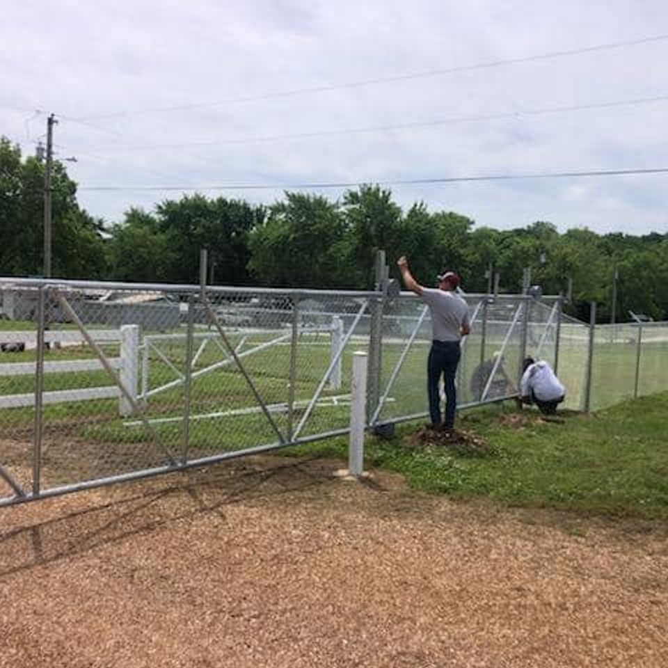 Dore team installing commercial chain link fence