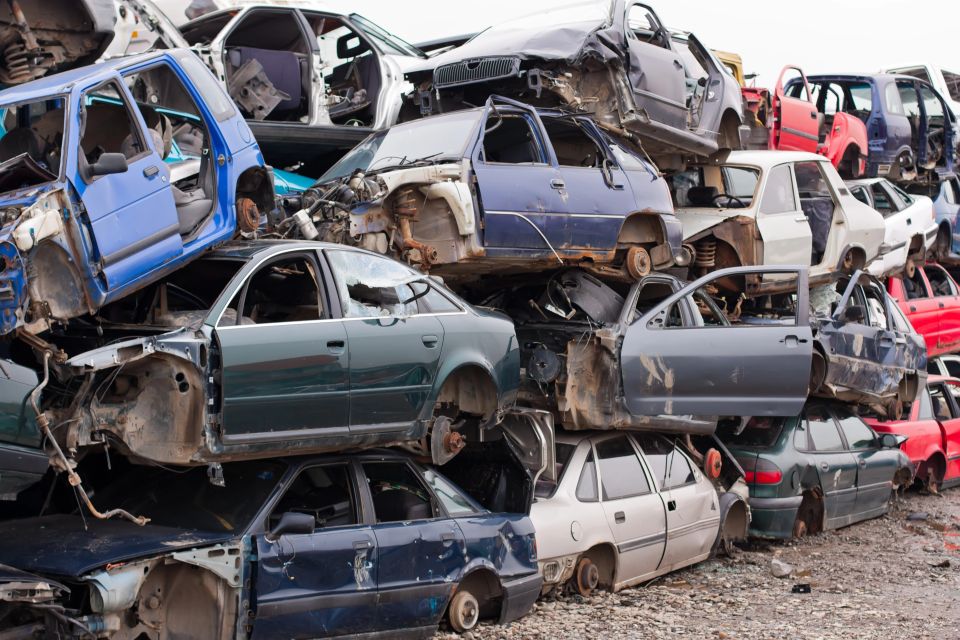 Piled up destroyed cars in the junkyard.