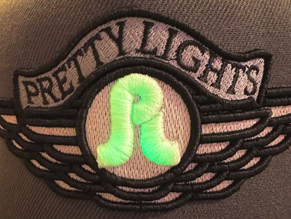 LOT Pretty Lights glow-in-the-dark embroidered patch on hat.