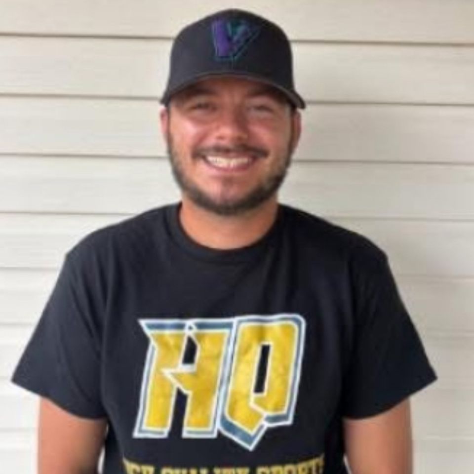 Photo of Dillon Upperman, a baseball and softball performance trainer at High Quality Sports Performance in Benton, Arkansas, wearing an HQ Sports shirt and smiling.