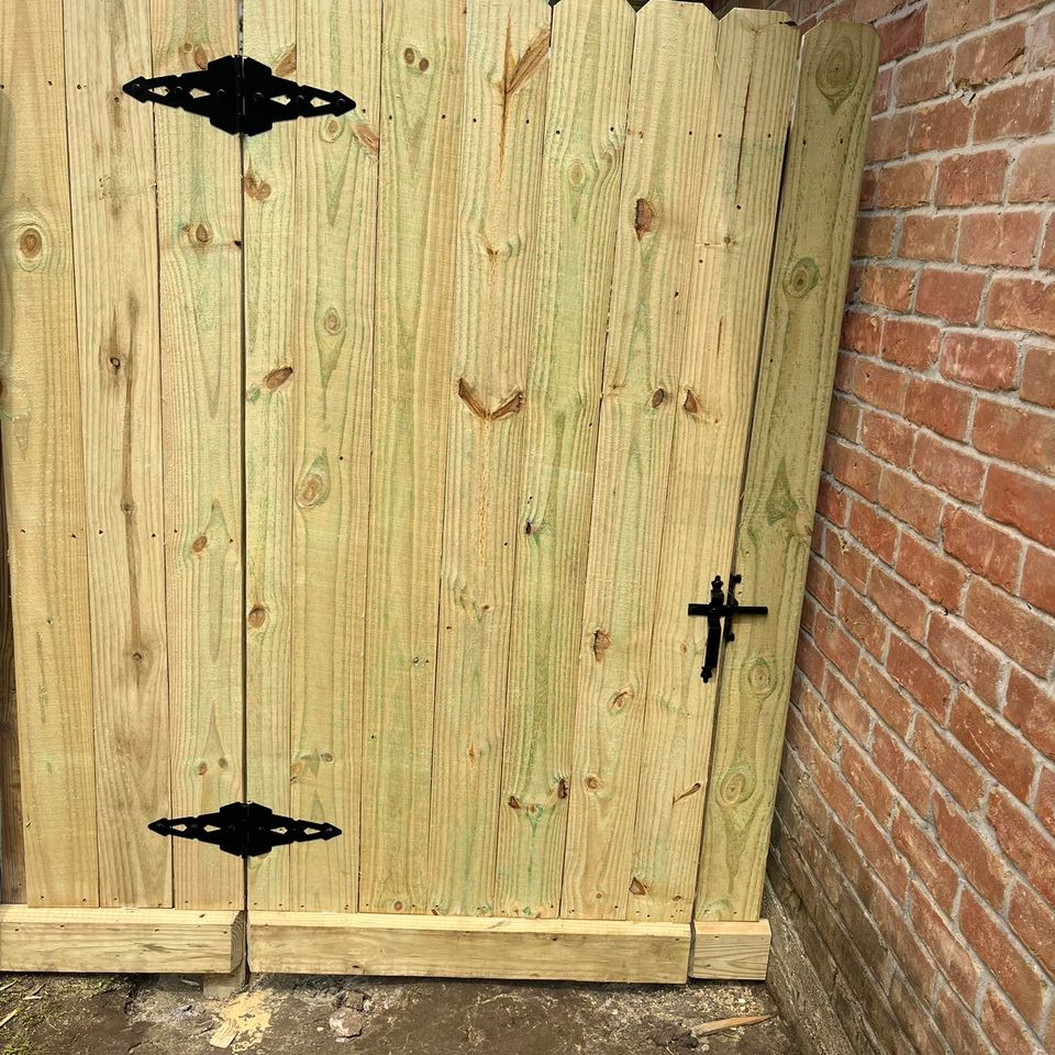 Wood picket walk-through gate made from treated lumber and custom metal framing by Marquez Welding in Houston