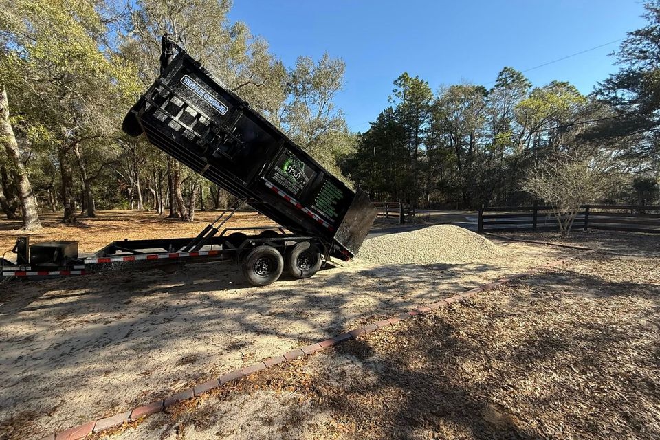 The JNJ dumpster in the downward position emptying out after a job during a sunny day in Citrus County