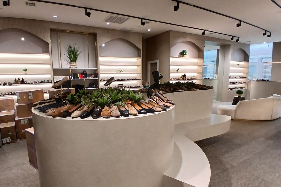 Modern shoe store with custom-built cabinetry and display shelving by Ultimate Kitchens.