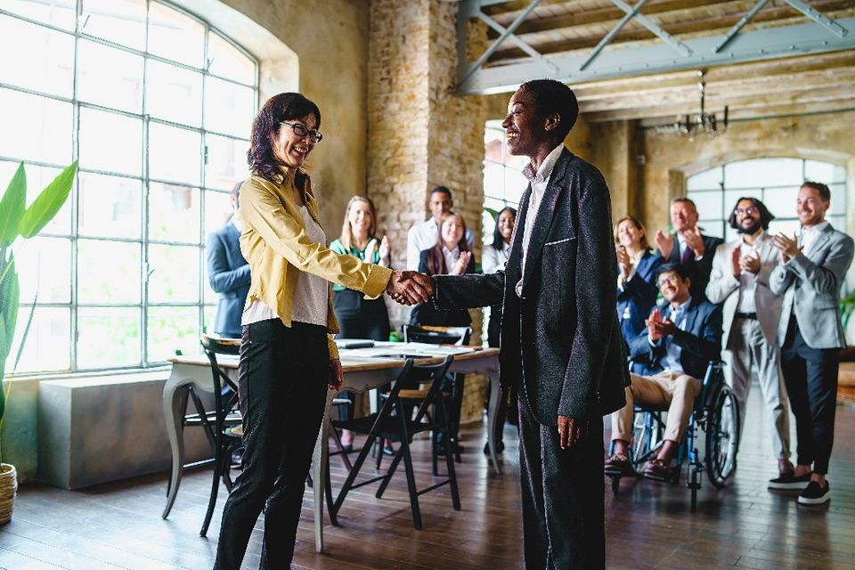 Two business women shake hands 2023 11 27 05 05 02 utc