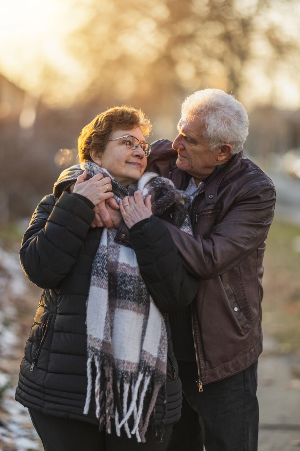 Senior couple in a hug enjoying walk together in the city street