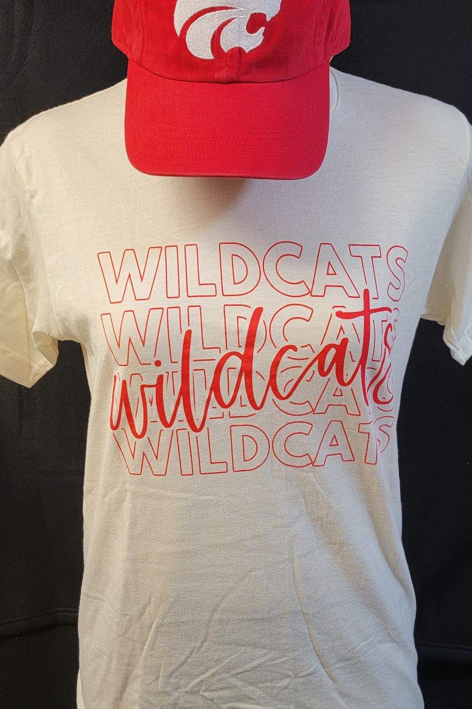 Example of Direct to Film (DTF) - Wildcats school name and logo on a white t-shirt and red cap.
