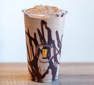 PBC smoothie made with oat milk, frozen yogurt, peanut butter, cocoa powder, and topped with chocolate drizzle.