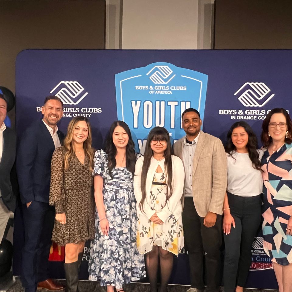 Group of people posing for photo at an event
