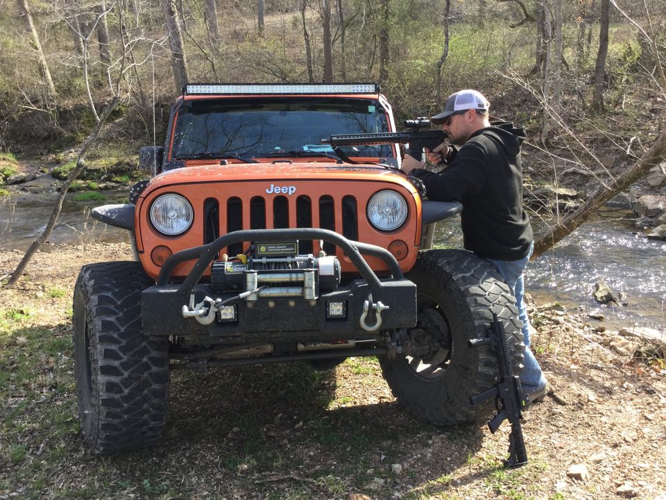 Gun w jeep by river