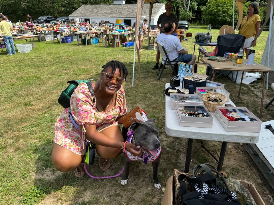 A shopper and her four-legged friend peruse the jewelry and handbags. 