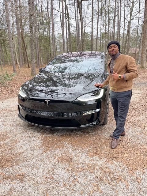 Abner shotwell with black tesla front closeup min