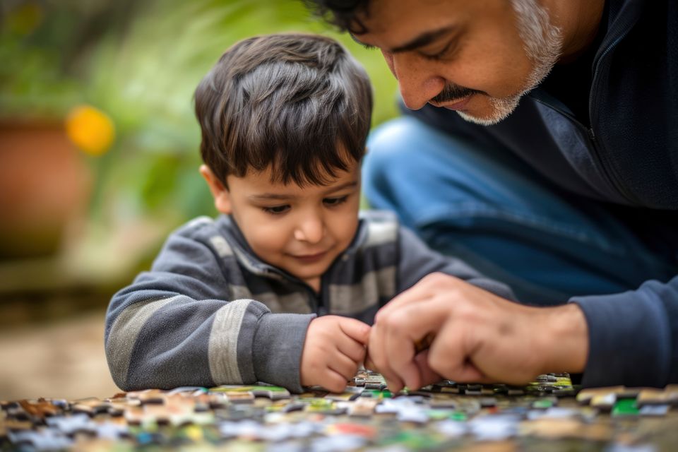 Young child with autism playing with family
