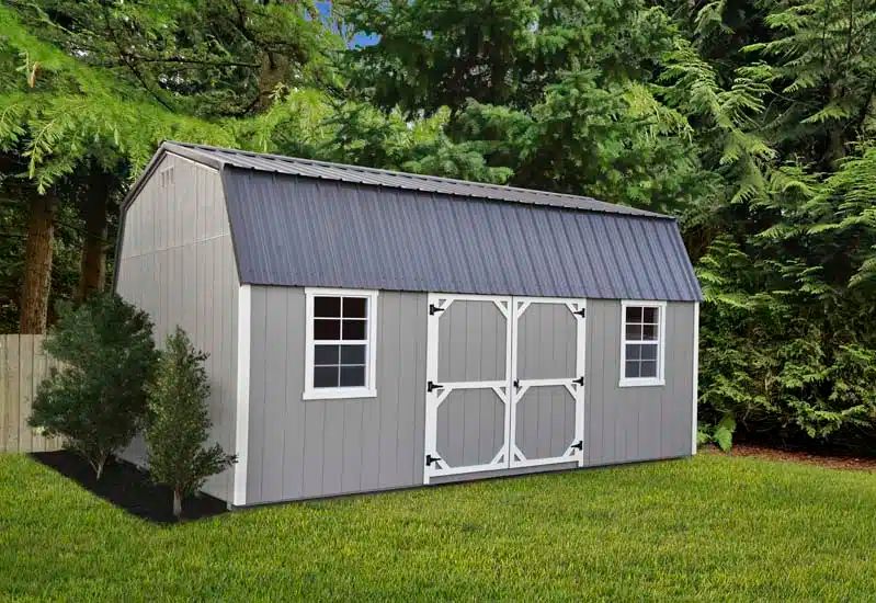 Gray high wall barn shed with white trim, windows and double doors on a Knoxville TN lawn