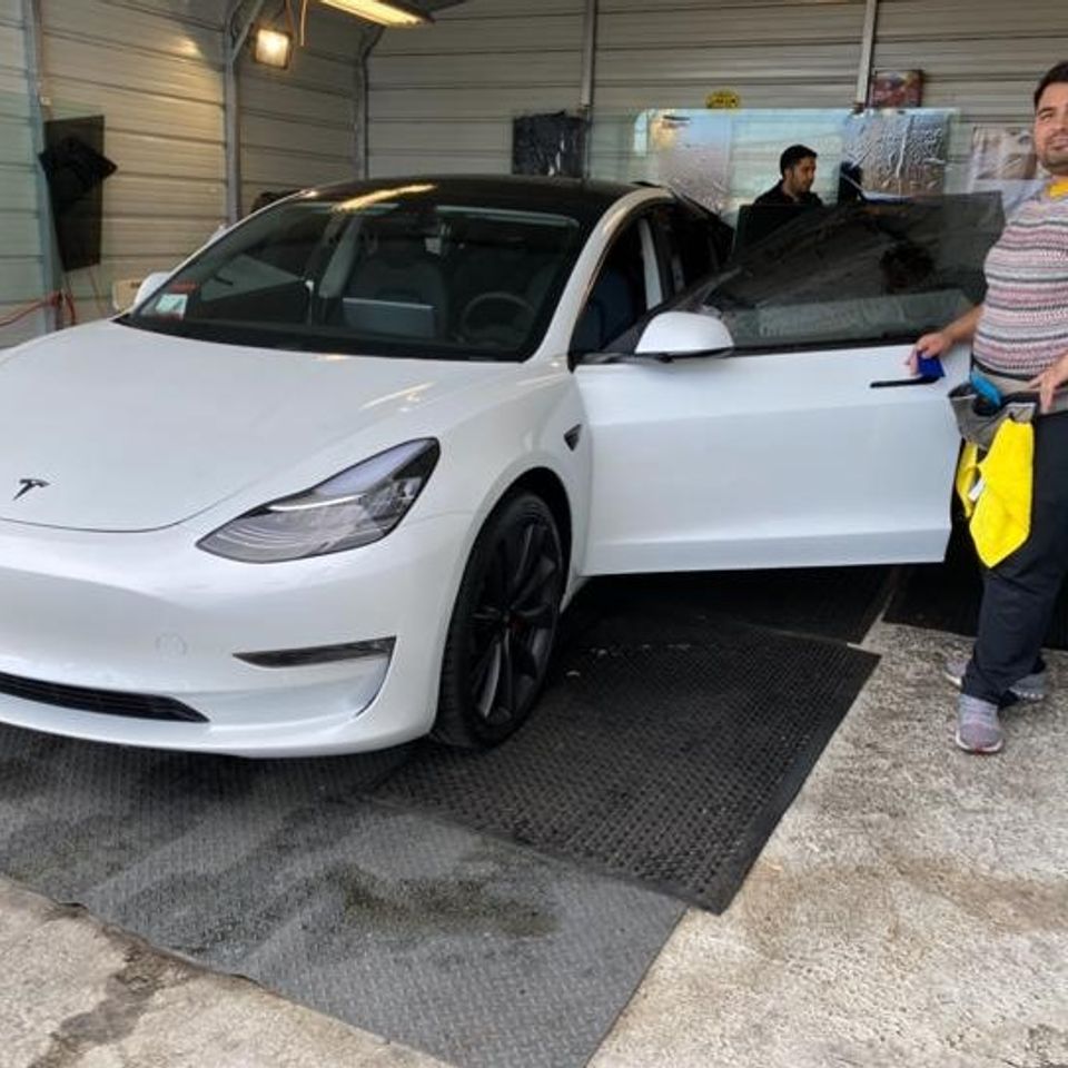 White Tesla in a tint shop for gallery