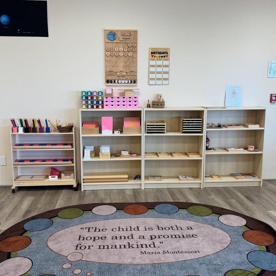 Montessori classroom shelves lined with learning materials beside a circle time rug at a preschool in Palmdale CA