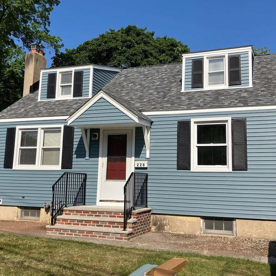 house with blue siding and new roof